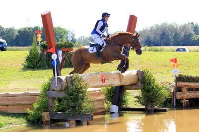 Lucy Richards and Obie jumping into the water during a cross country 